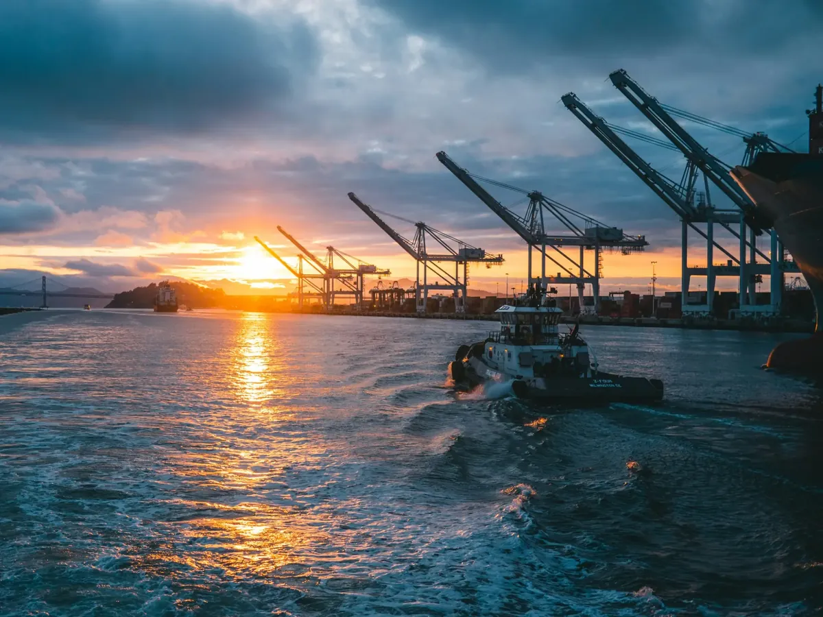 Port terminal and cargo cranes at sunset